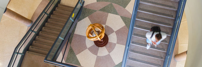 Student walks down the stairs inside the Science Laboratory Building.