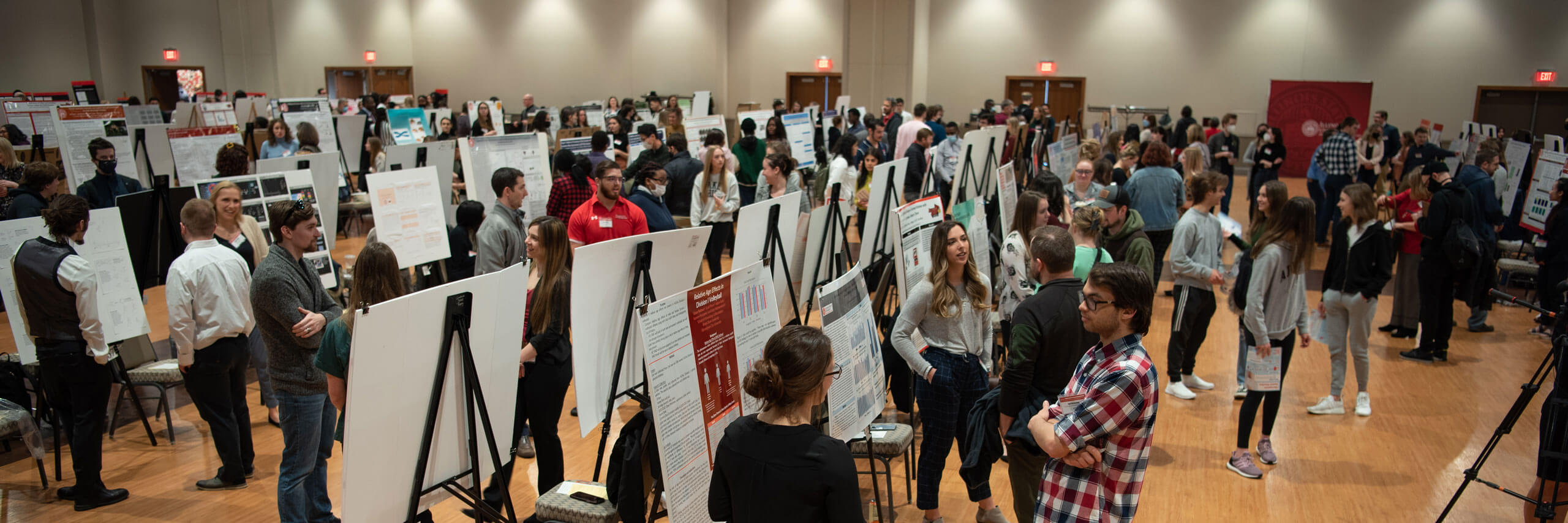 Research Symposium featuring many presenters with posterboards.